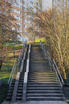 A long, concrete staircase between the different levels of the city park. Stock Photos