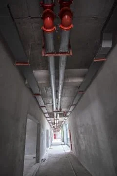Long Corridor in Construction Project Fire Pipes Stock-Fotos
