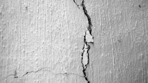Long crack in the white ceiling of an old rural house close-up. The camera moves Stock Footage 210205719