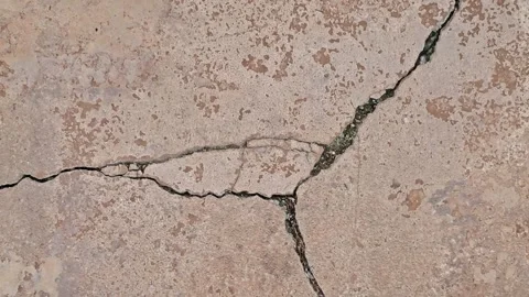 Long cracks in the ground cement concrete surface may be caused by earthqua.. Stock Footage 313251667