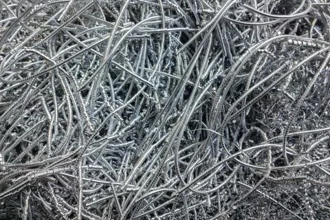 Long curly aluminium chips pattern background with selective focus Stock Photos