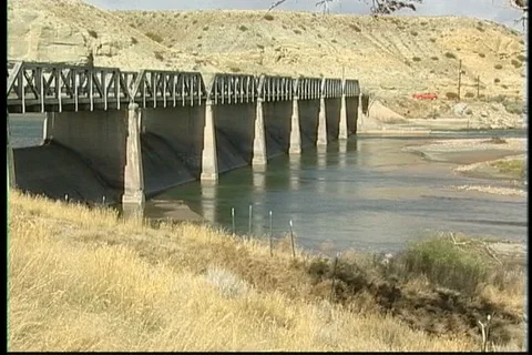 Long Dam and Bridge below Rugged Bluffs Stock Footage 121523517
