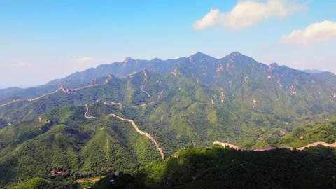 Long defensive Great Wall tracing rugged mountains above shaded slopes 스톡 동영상 346575662