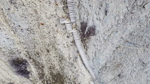 Long descent down wooden steps to a beautiful, wild beach. Stock Footage 151961948
