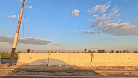 Long desert highway experience across Cairo Fayoum Desert Road open road views Stock Footage 330088992