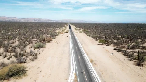 Long desert road in La Paz, Mexico, stretching through a barren and tranquil Stock Footage 311048472