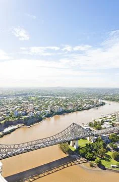 Long designed bridge on Mud lake and city. Stock Photos