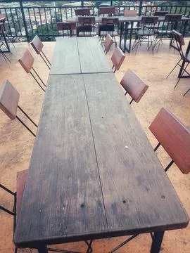 A long dining table made of strong wood. Stock Photos