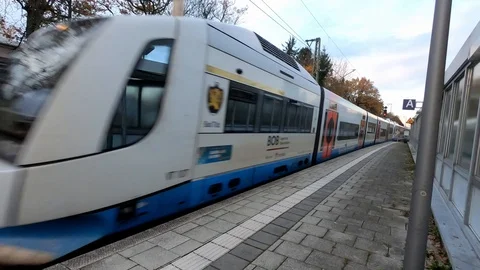 Long-distance express train passes along a platform at the station on an autumn Stock Footage 119845806