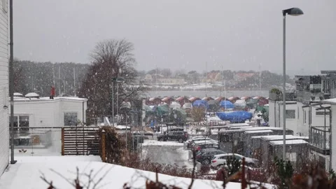 Long distance view of a big yellow house on an small island in heavy snowall Stock Footage 150215902