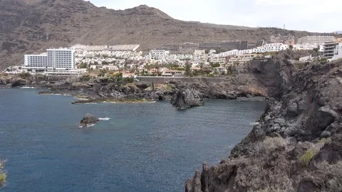 Long distance view of the coast line and resort in Los Gigantes Tenerife Spain Stock-Footage 80801236