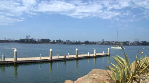Long Dock Stretching Out To Sea - Yacht Sailing By In The Distance Video stock 157792123