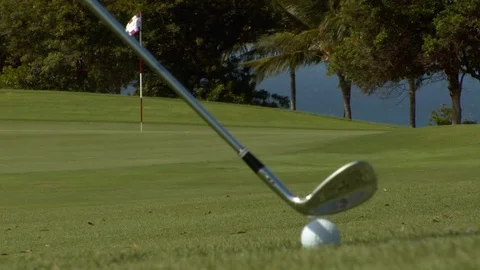 Long drive golf hit or chip close up oceanside putting green Stock Footage 125336460