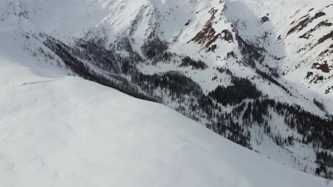 Long drone shot of epic snow covered mountain scenery Stock Footage 145801284