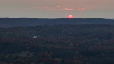 Long Drone Shot of Sunset over Small Town and Forest Stock Footage 241940287
