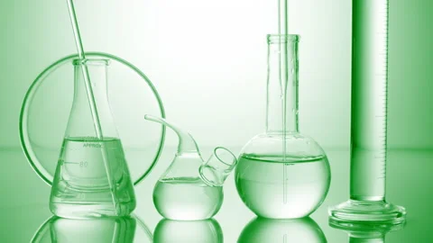 Long dropper is lowered into flask surrounded by lab glassware Stock Footage 167168650