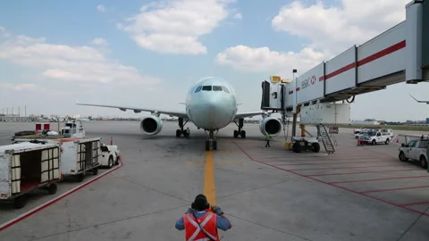 Long Duration Airplane Arriving at Gate with Ramp Agent Directing Plane (Part 2) Stock Footage 219227430