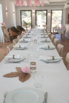 Long elegantly decorated party table in a bright room Stock Photos