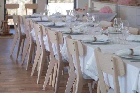 Long elegantly set party table in a bright room Fotos Stock