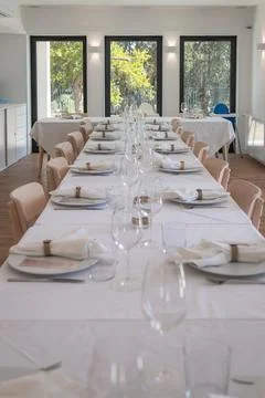 Long elegantly set party table in a bright room Fotos Stock