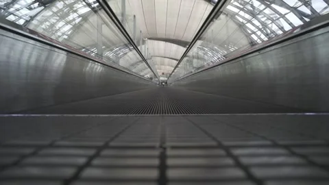 A long, empty, and dark tunnel with a glass ceiling Stock Footage 313394977