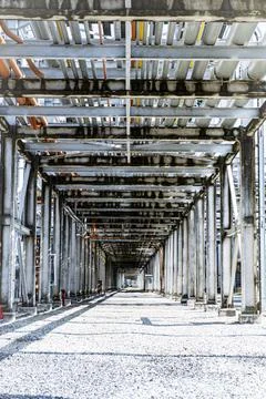 Long, empty, and empty tunnel with pipes and wires Stock Photos
