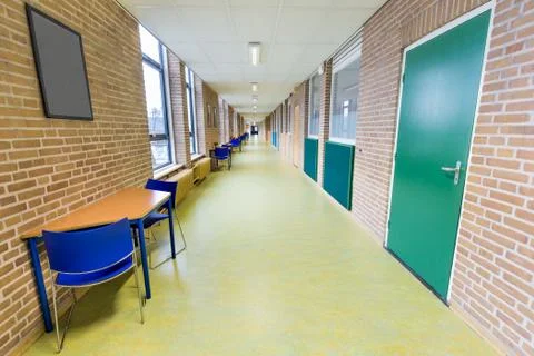 Long empty corridor in college school building Stock Photos