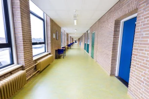 Long empty corridor in high school building Stock Photos