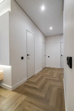 Long empty corridor in interior of entrance hall of modern apartments, office Stock Photos