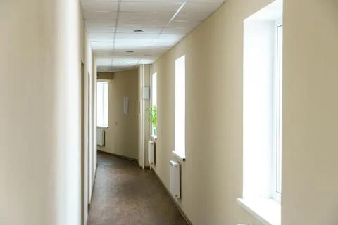 A long empty corridor in an office building. A new modern heating radiator on Fotos de archivo