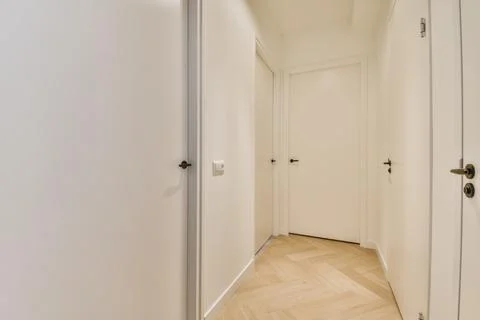 Long empty hallway with many doors Stock Photos