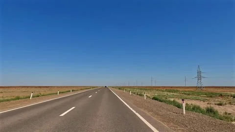 A long empty road with a blue sky overhead Video stock 317386330