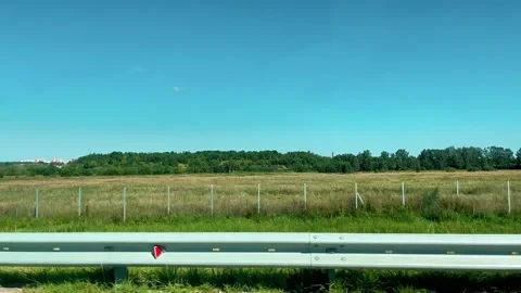 A long empty road with a fence on the side of the road. High speed. Stock Footage 314907961
