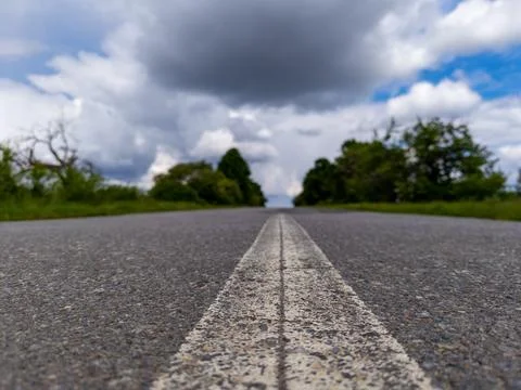 A long empty road with a white line on the side of it 스톡 사진
