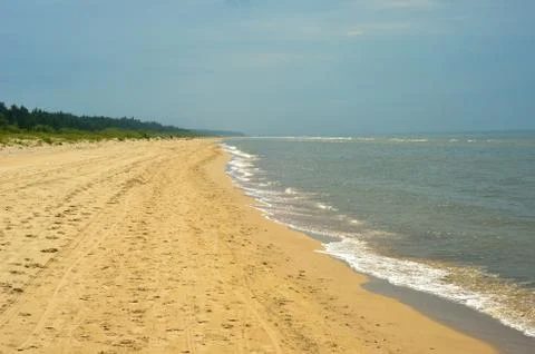 Long empty sandy beach. Stock Photos