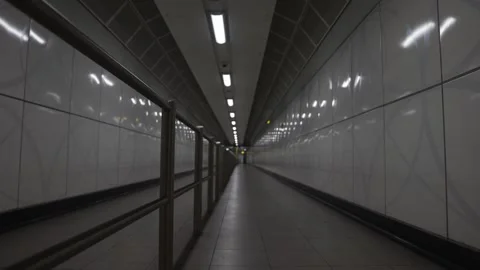 A long, empty subway tunnel with a white wall Stock Footage 297859545