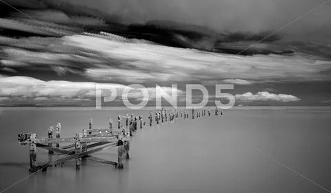 Long exposure black and white seascape landscape during dramatic evening Stock Photos