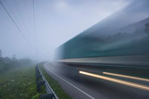 Long exposure of bus on highway in clouds Stock Photos