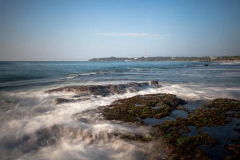 Long exposure capture with beach, reef and rocks.. Stock Photos