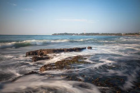 Long exposure capture with beach, reef and rocks.. Stock Photos