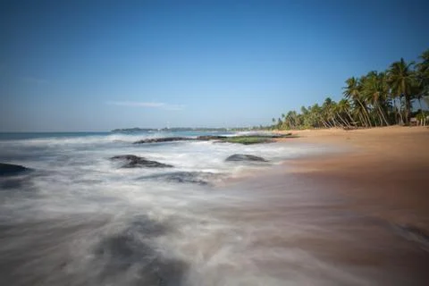 Long exposure capture with beach, reef and rocks.. Stock Photos