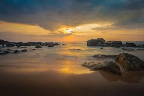 Long exposure capture with beach, reef and rocks.. Stock Photos