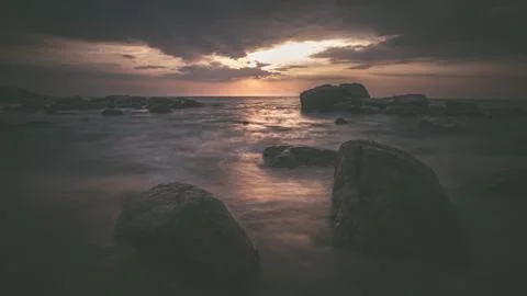 Long exposure capture with beach, reef and rocks.. Stock Photos