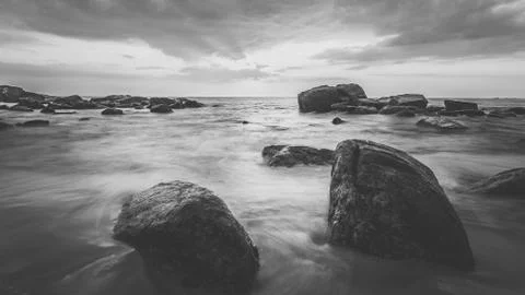 Long exposure capture with beach, reef and rocks.. Stock Photos