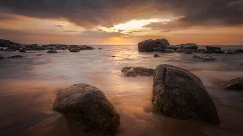 Long exposure capture with beach, reef and rocks.. Stock Photos