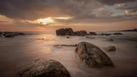 Long exposure capture with beach, reef and rocks.. Stock Photos