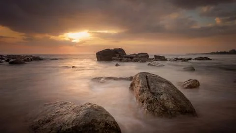 Long exposure capture with beach, reef and rocks.. Stock Photos