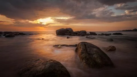 Long exposure capture with beach, reef and rocks.. Stock Photos