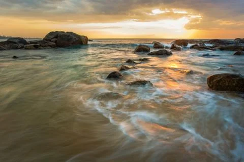 Long exposure capture with beach, reef and rocks.. Stock Photos