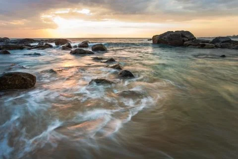 Long exposure capture with beach, reef and rocks.. Stock Photos